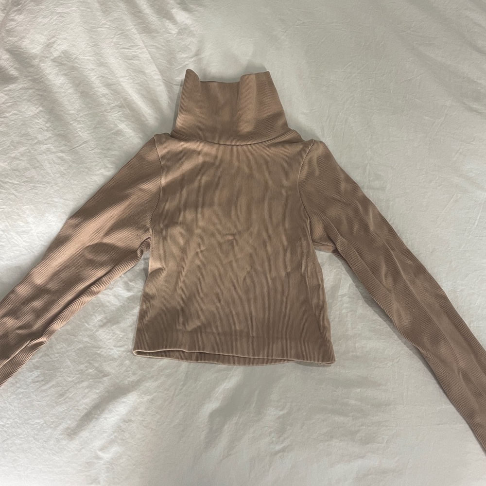 Tan form fitting turtleneck